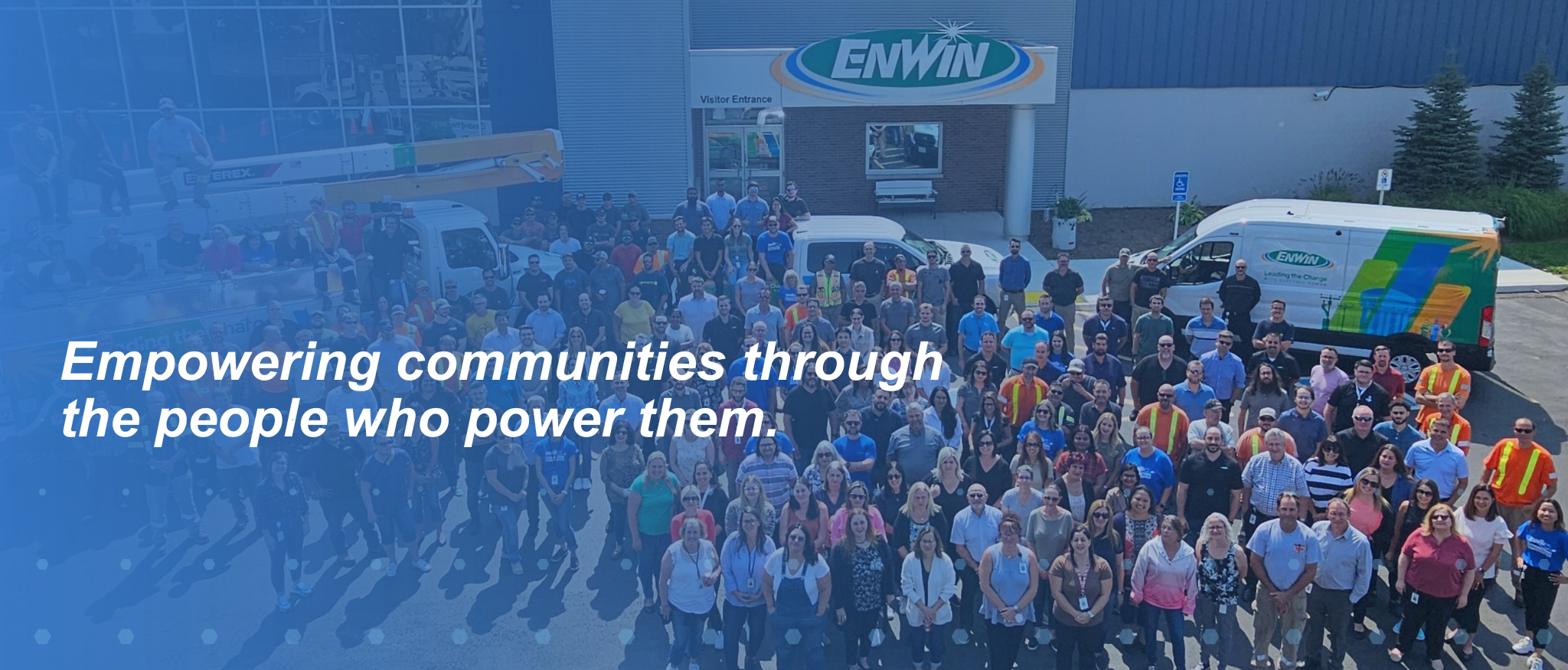 Group photo of ENWIN employees in front of ENWIN headquarters, representing the people who support and strengthen local communities.