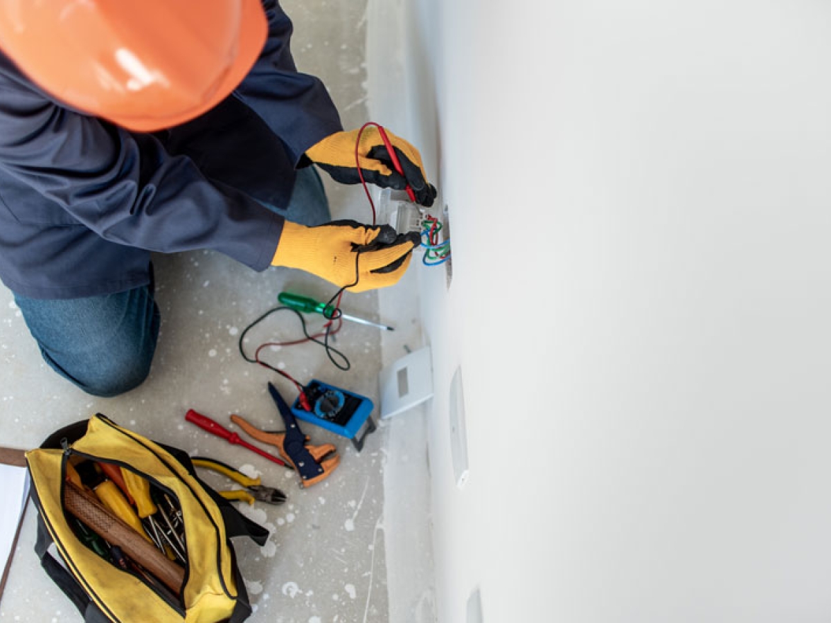 A worker installing an electric outlet